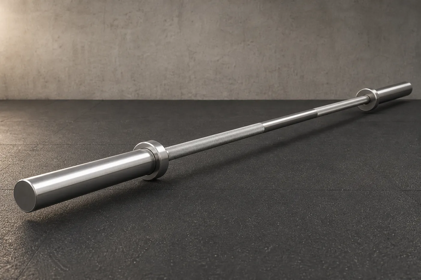 A plain unbranded Olympic weightlifting barbell with rotating sleeves, on a gym floor.